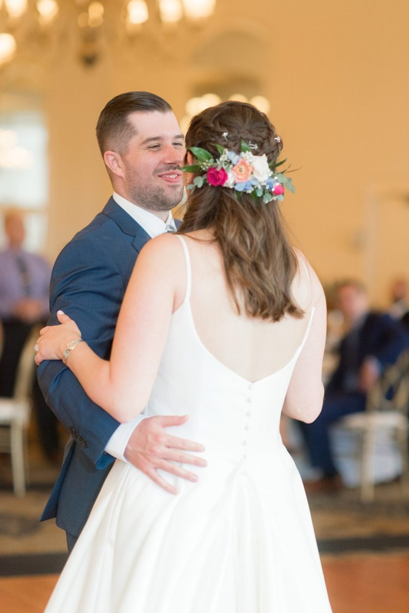 New Jersey wedding venue, Crystal Springs Resort, in Hamburg with an outdoor ceremony option and indoor reception. Photos by Mikkel Paige Photography. The bride wore a simple classic white dress with flowers in her hair and groom a blue suit and floral tie. #mikkelpaige #CrystalSprings #NJweddingvenues #NewJerseyWedding #NJweddingphotographer #brideandgroom