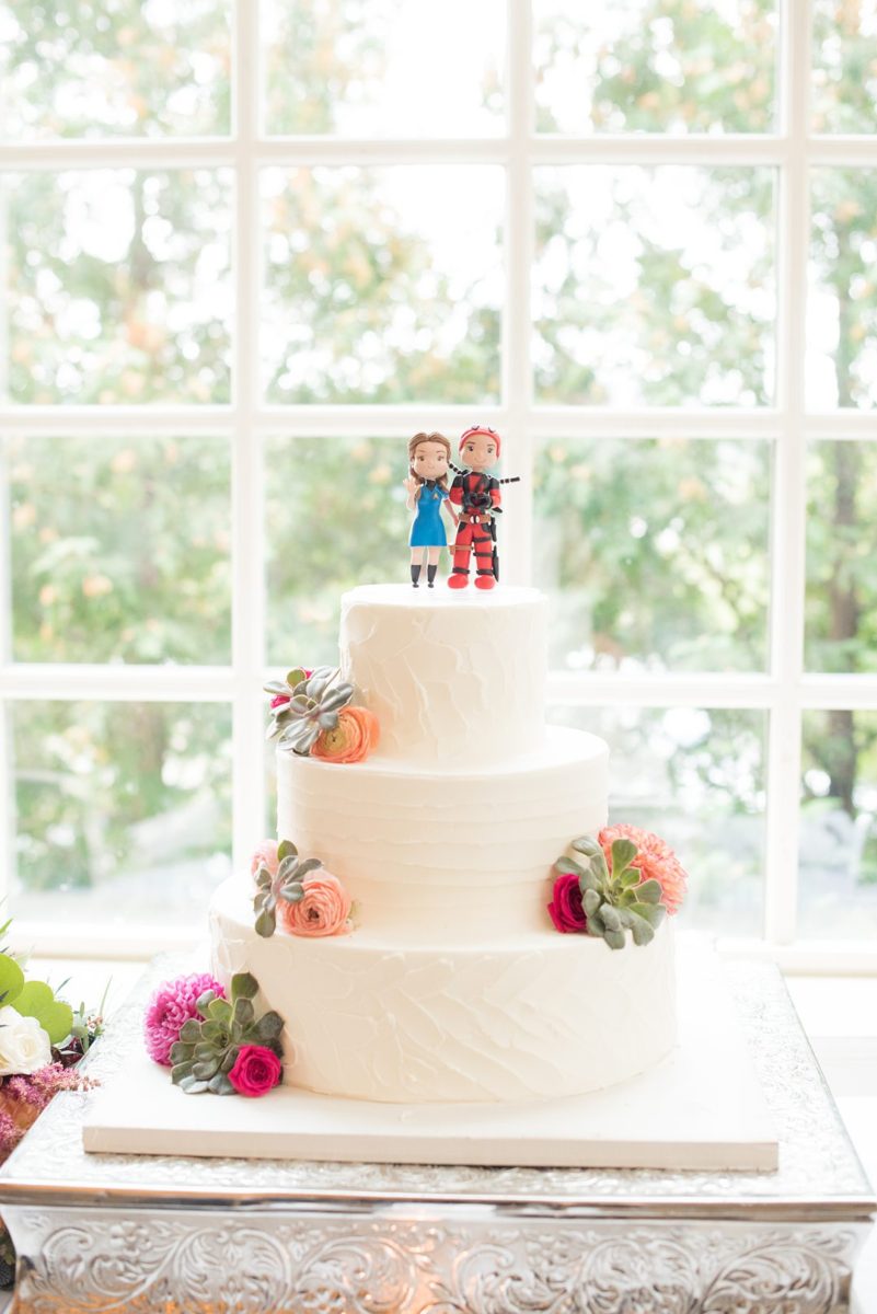New Jersey wedding venue, Crystal Springs Resort, in Hamburg with an outdoor ceremony option and indoor reception. Photos by Mikkel Paige Photography. Their white buttercream wedding cake was decorated with colorful flowers and a custom cake topper. It was clay models of gamers! #mikkelpaige #CrystalSprings #NJweddingvenues #NewJerseyWedding #NJweddingphotographer #brideandgroomcaketopper #caketopper #gamers