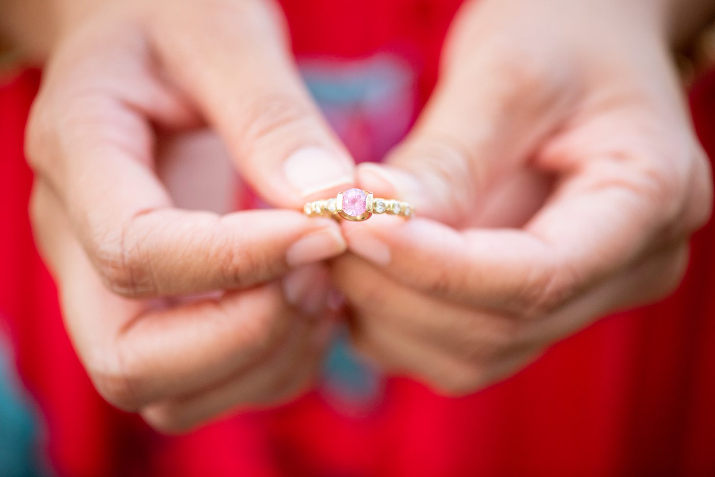 Durham North Carolina wedding photographer, Mikkel Paige Photography, captures engagement photos for a couple in the downtown area of the NC city. The bride has a unique pink gemstone and diamond ring in yellow gold with a singular setting. #mikkelpaige #DurhamEngagementPhotos #DowntownDurham #DurhamWeddingPhotographer