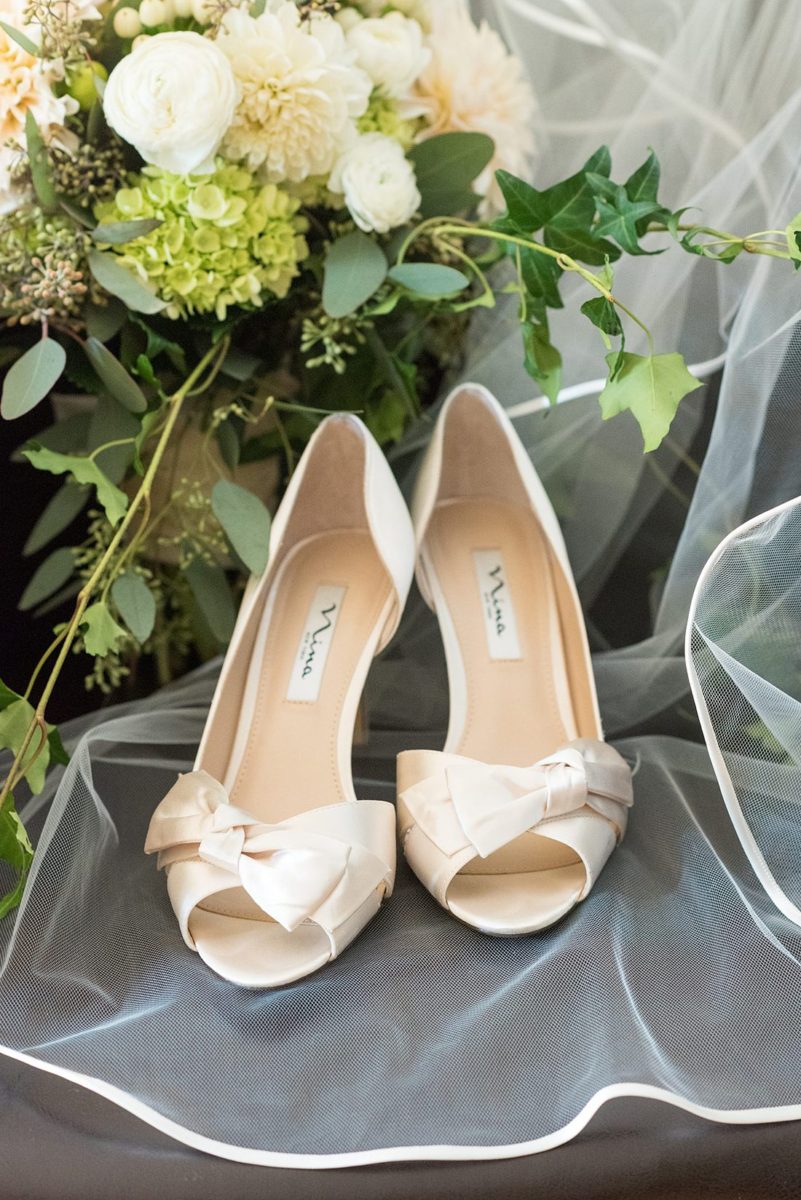 Fall wedding in upstate New York, just outside NYC, in Chappaqua, Westchester County. The wedding at Crabtree's Kittle House had an outdoor ceremony then reception indoors. It was filled with pumpkins, autumn leaves, orange, white, and peach colors. Detail white heel shoe photos for the bride taken by Mikkel Paige Photography. #mikkelpaige #fallwedding #newyorkweddingvenues #nycweddingphotographer #outdoorceremony #autumnwedding #bridestyle #brideshoes