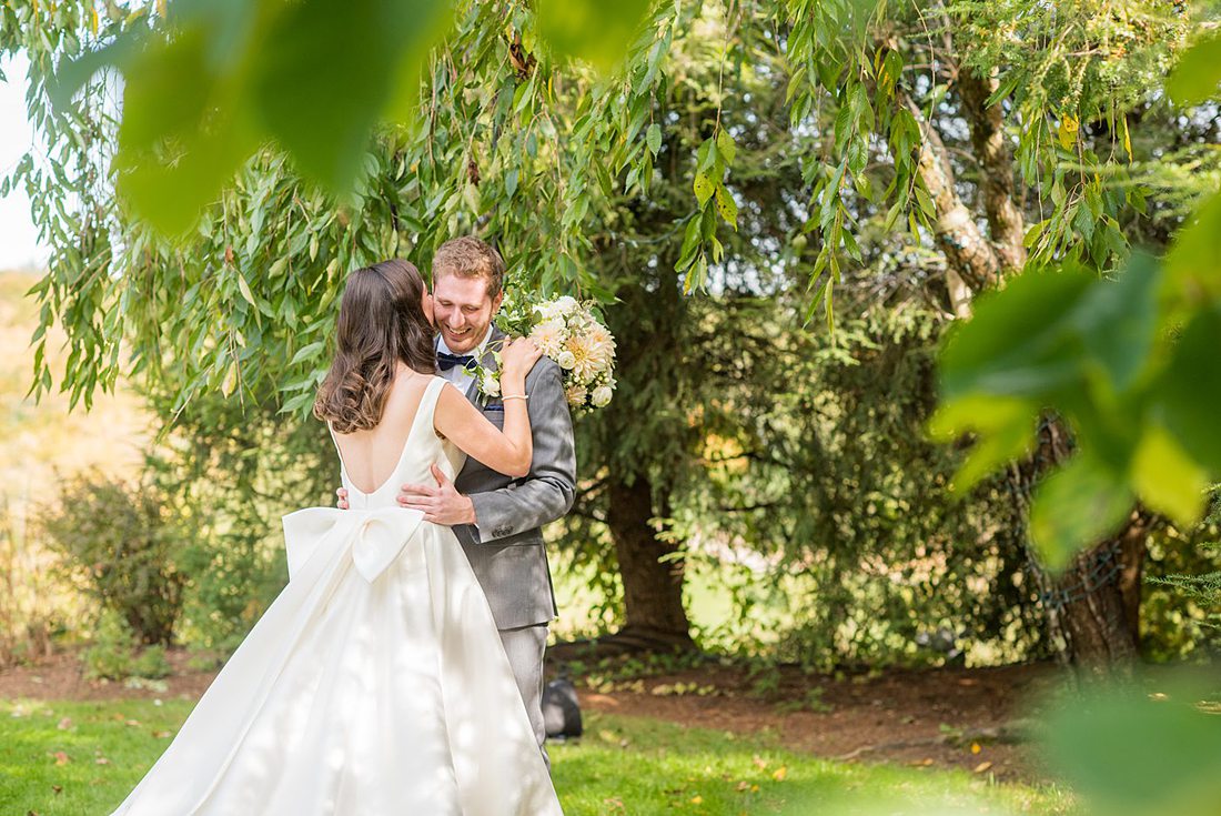 Photographs were taken by Mikkel Paige Photography for a fall wedding in upstate New York, just outside NYC, in Chappaqua, Westchester County. The bride and groom got married at Crabtree's Kittle House outdoors with an indoor reception. It was filled with pumpkins, autumn leaves, orange, white, peach and navy colors. The bride's gown had a long train and back bow. #mikkelpaige #fallwedding #newyorkweddingvenues #upstatenewyorkweddingvenues #nycweddingphotographer #BrideStyle #autumnbouquet