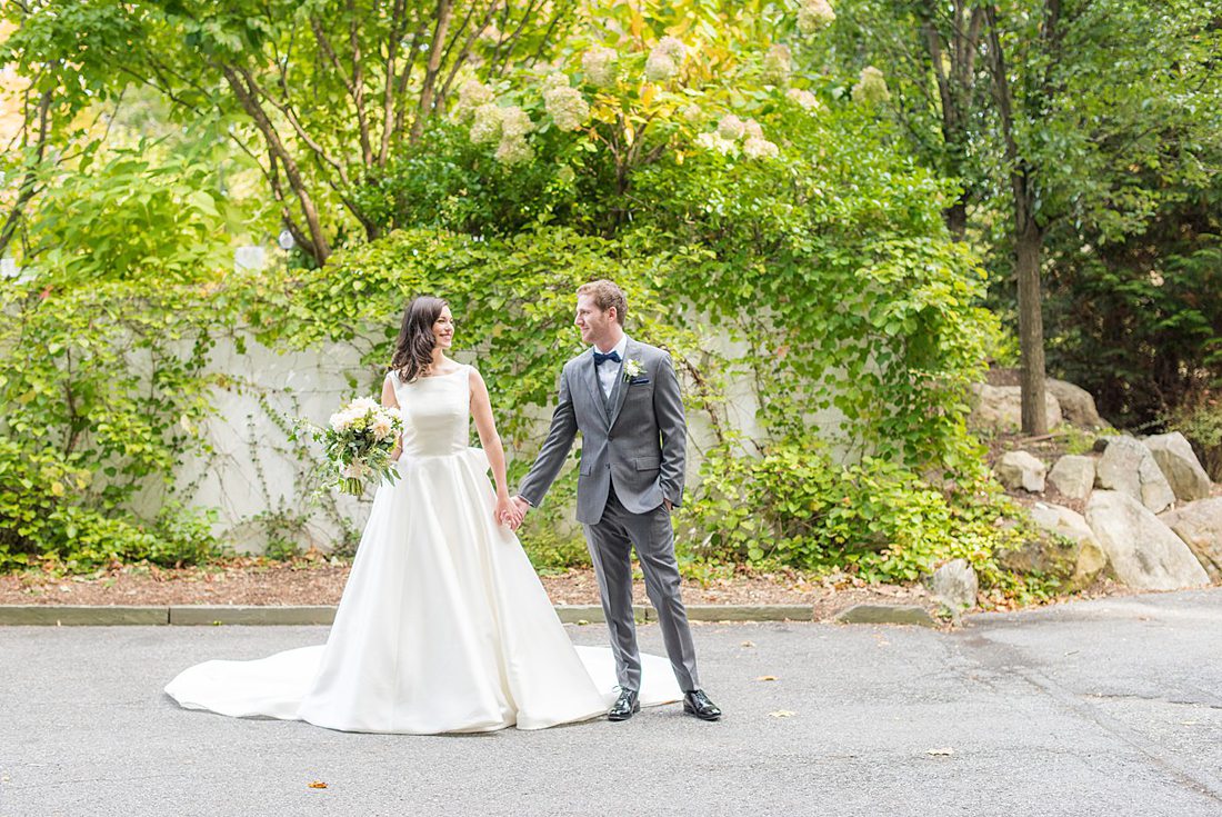 Photographs were taken by Mikkel Paige Photography for a fall wedding in upstate New York, just outside NYC, in Chappaqua, Westchester County. The bride and groom got married at Crabtree's Kittle House outdoors with an indoor reception. It was filled with pumpkins, autumn leaves, orange, white, peach and navy colors. The bride's gown had a long train and back bow. #mikkelpaige #fallwedding #newyorkweddingvenues #upstatenewyorkweddingvenues #nycweddingphotographer #BrideStyle #autumnbouquet