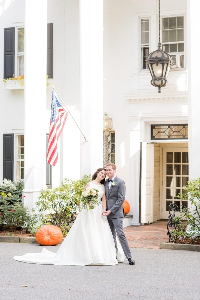 Photographs were taken by Mikkel Paige Photography for a fall wedding in upstate New York, just outside NYC, in Chappaqua, Westchester County. The bride and groom got married at Crabtree's Kittle House outdoors with an indoor reception. It was filled with pumpkins, autumn leaves, orange, white, peach and navy colors. The bride's gown had a long train and back bow. #mikkelpaige #fallwedding #newyorkweddingvenues #upstatenewyorkweddingvenues #nycweddingphotographer #BrideStyle #autumnbouquet