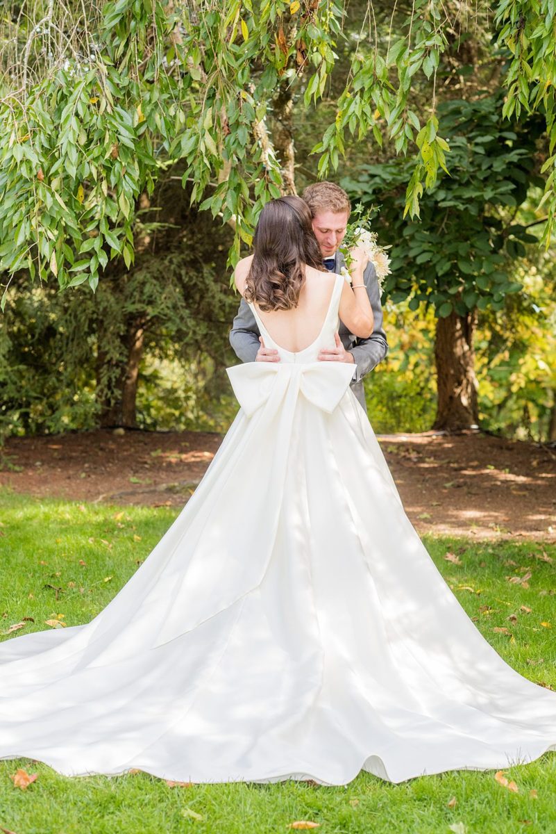 Photographs were taken by Mikkel Paige Photography for a fall wedding in upstate New York, just outside NYC, in Chappaqua, Westchester County. The bride and groom got married at Crabtree's Kittle House outdoors with an indoor reception. It was filled with pumpkins, autumn leaves, orange, white, peach and navy colors. The bride's gown had a long train and back bow. #mikkelpaige #fallwedding #newyorkweddingvenues #upstatenewyorkweddingvenues #nycweddingphotographer #BrideStyle #autumnbouquet