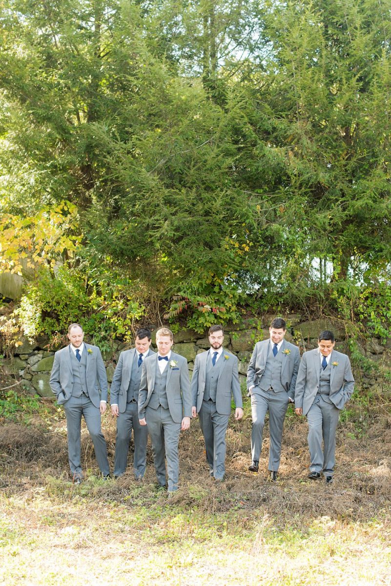 Groomsmen dressed in grey suits for a fall wedding in upstate New York, just outside NYC, in Chappaqua, Westchester County. The wedding at Crabtree's Kittle House had an outdoor ceremony then reception indoors. It was filled with pumpkins, autumn leaves, orange, white, and peach colors. Photos taken by Mikkel Paige Photography. #mikkelpaige #fallwedding #newyorkweddingvenues #nycweddingphotographer #outdoorceremony #greygroomsmen #autumnwedding