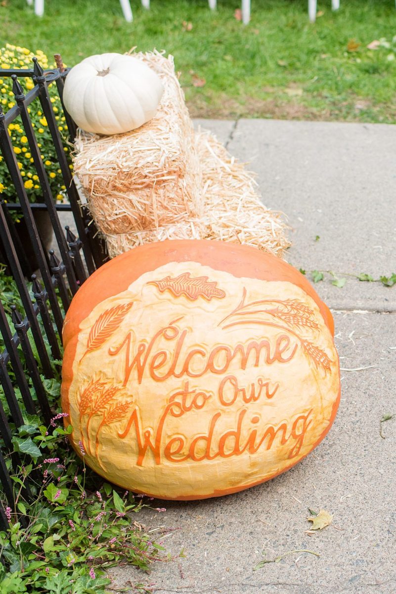 A fall wedding in upstate New York, just outside NYC, in Chappaqua, Westchester County. Photos taken by Mikkel Paige Photography at Crabtree's Kittle House. Ceremony outside and reception indoors, filled with custom carved pumpkins, autumn leaves, orange, white, and peach colors, berries, pears, pomegranates and sunflowers. #mikkelpaige #fallwedding #newyorkweddingvenues #nycweddingphotographer #outdoorceremony #autumnwedding #fallharvest