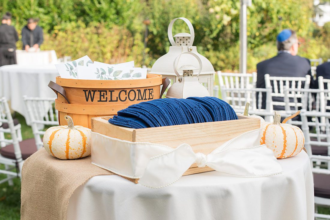 Fall wedding in upstate New York, just outside NYC, in Chappaqua, Westchester County. This bride and groom got married outdoors in a Jewish ceremony with a rabbi at Crabtree's Kittle House then celebrated inside for their reception. It was filled with pumpkins, autumn leaves, orange, white, peach and navy colors. Photos taken by Mikkel Paige Photography. #mikkelpaige #fallwedding #newyorkweddingvenues #nycweddingphotographer #outdoorceremony #welcometable #jewishceremony