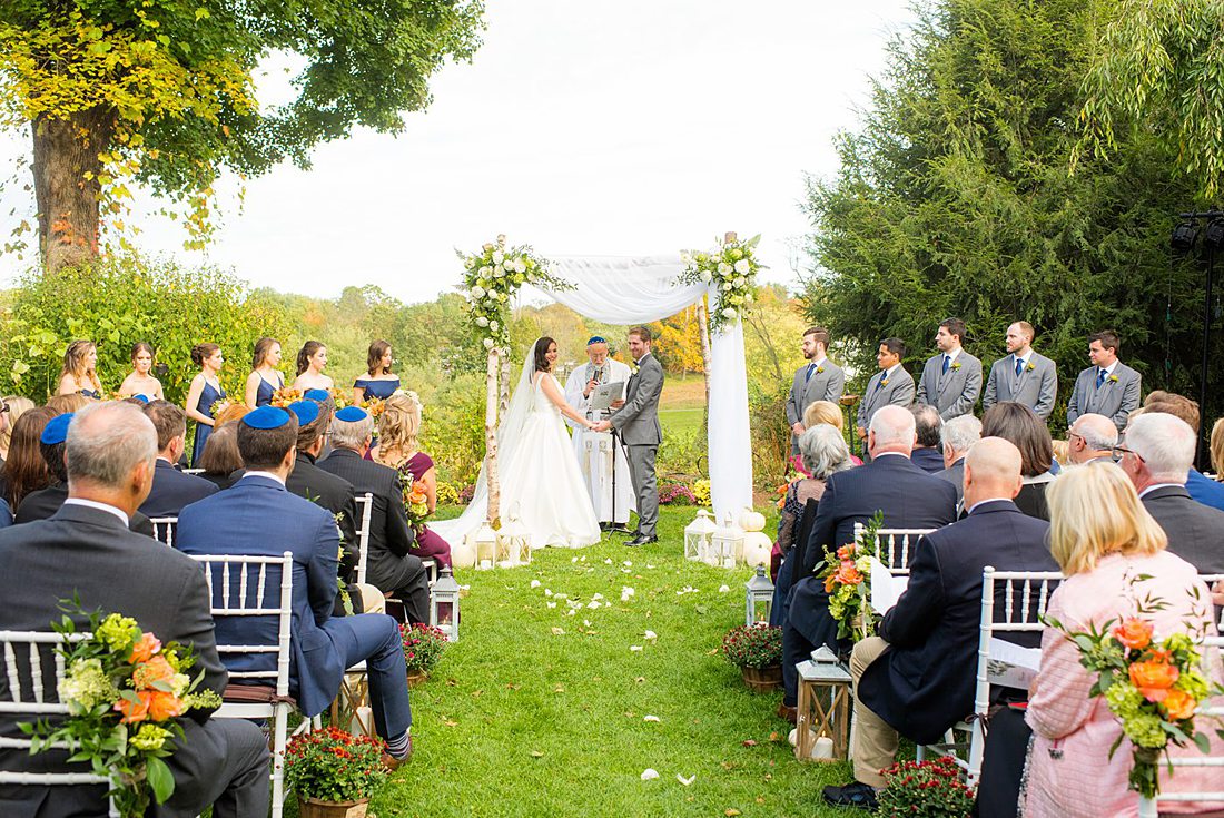 Fall wedding in upstate New York, just outside NYC, in Chappaqua, Westchester County. This bride and groom got married at Crabtree's Kittle House in an outdoor ceremony then celebrated inside for their reception. It was filled with pumpkins, autumn leaves, orange, white, peach and navy colors. Photos taken by Mikkel Paige Photography of their white gold diamond rings. #mikkelpaige #fallwedding #newyorkweddingvenues #upstatenewyorkweddingvenues #nycweddingphotographer #outdoorceremony