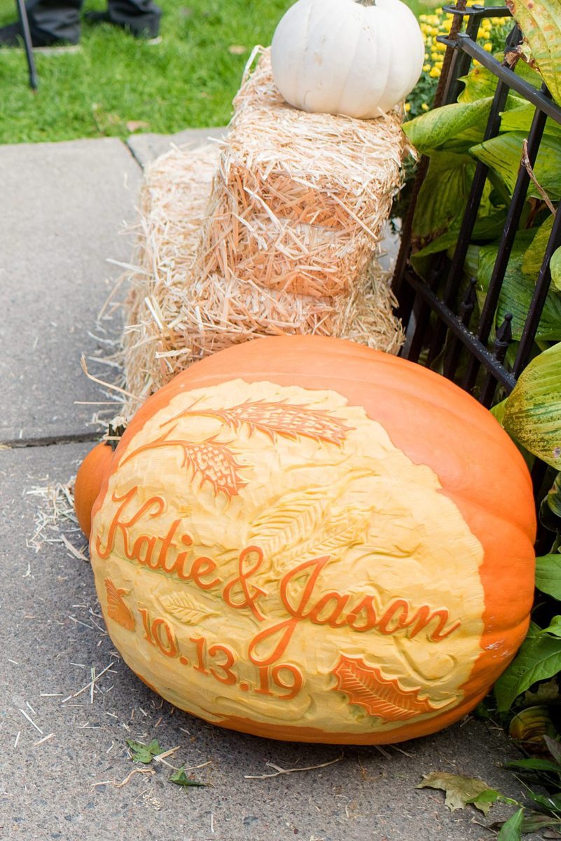 A fall wedding in upstate New York, just outside NYC, in Chappaqua, Westchester County. Photos taken by Mikkel Paige Photography at Crabtree's Kittle House. Ceremony outside and reception indoors, filled with custom carved pumpkins, autumn leaves, orange, white, and peach colors, berries, pears, pomegranates and sunflowers. #mikkelpaige #fallwedding #newyorkweddingvenues #nycweddingphotographer #outdoorceremony #autumnwedding #fallharvest