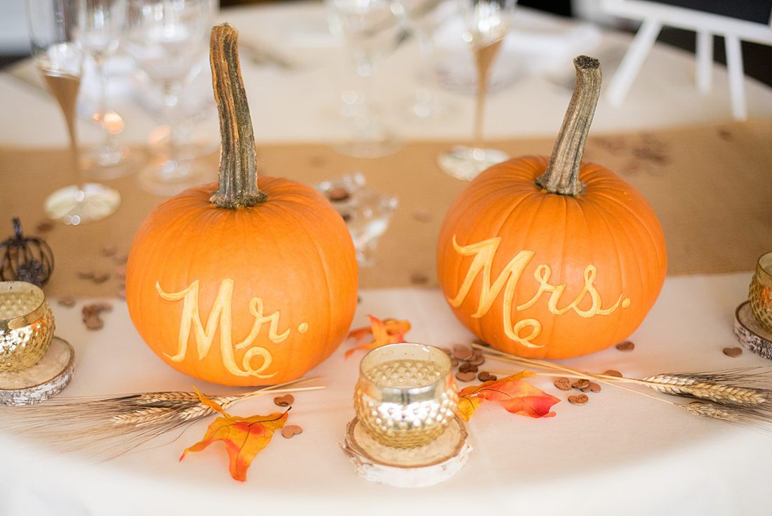 A fall wedding in upstate New York, just outside NYC, in Chappaqua, Westchester County. Photos taken by Mikkel Paige Photography at Crabtree's Kittle House. Ceremony outside and reception indoors, filled with custom carved pumpkins, autumn leaves, orange, white, and peach colors, berries, pears, pomegranates and sunflowers. #mikkelpaige #fallwedding #newyorkweddingvenues #nycweddingphotographer #outdoorceremony #autumnwedding #appleciderdonuts