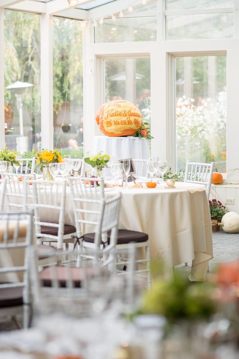 A fall wedding in upstate New York, just outside NYC, in Chappaqua, Westchester County. Photos taken by Mikkel Paige Photography at Crabtree's Kittle House. Ceremony outside and reception indoors, filled with custom carved pumpkins, autumn leaves, orange, white, and peach colors, berries, pears, pomegranates and sunflowers. #mikkelpaige #fallwedding #newyorkweddingvenues #nycweddingphotographer #outdoorceremony #autumnwedding #fallharvest