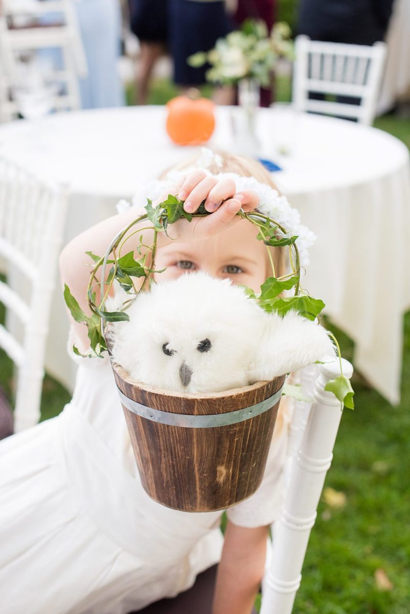 Fall wedding in upstate New York, just outside NYC, in Chappaqua, Westchester County. This bride and groom got married at Crabtree's Kittle House outdoors, then celebrated inside for their reception. It was filled with pumpkins, autumn leaves, orange, white, peach and navy colors. Photo taken by Mikkel Paige Photography of the her flower girl with her basket. #mikkelpaige #fallwedding #newyorkweddingvenues #upstatenewyorkweddingvenues #nycweddingphotographer #flowergirl