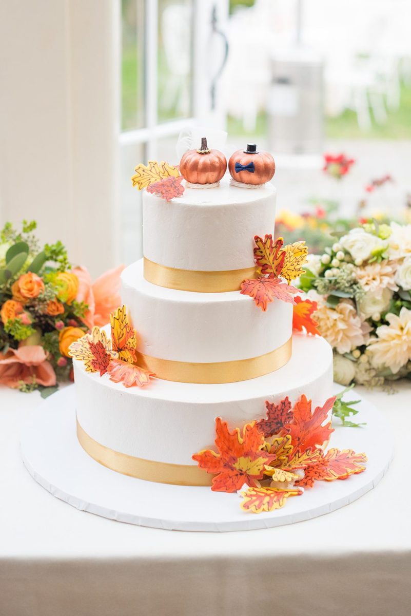 A fall wedding in upstate New York, just outside NYC, in Chappaqua, Westchester County. Photos taken by Mikkel Paige Photography at Crabtree's Kittle House. Ceremony outside and reception indoors filled with orange, white, and peach colors, berries, pears, pomegranates and sunflowers. The couple had a cake with autumn leaves and pumpkin bride and groom toppers for dessert. #mikkelpaige #fallwedding #newyorkweddingvenues #nycweddingphotographer #autumnwedding #fallharvest #pumpkincake