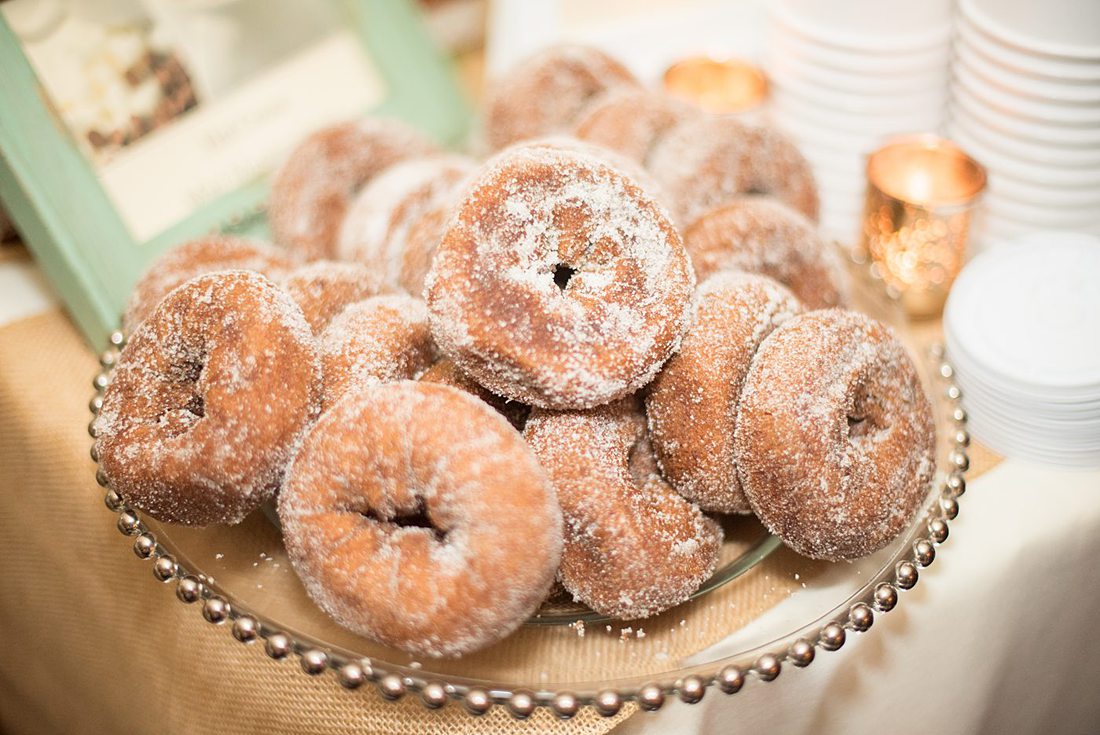 A fall wedding in upstate New York, just outside NYC, in Chappaqua, Westchester County. Photos taken by Mikkel Paige Photography at Crabtree's Kittle House. Ceremony outside and reception indoors, filled with custom carved pumpkins, autumn leaves, orange, white, and peach colors, berries, pears, pomegranates and sunflowers. The couple had apple cider donuts for dessert. #mikkelpaige #fallwedding #newyorkweddingvenues #nycweddingphotographer #autumnwedding #fallharvest #appleciderdonuts