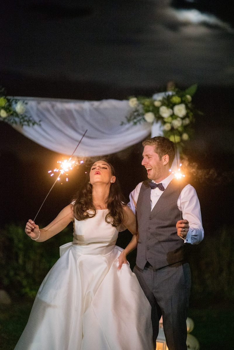 A fall wedding in upstate New York, just outside NYC, in Chappaqua, Westchester County. Photos taken by Mikkel Paige Photography at Crabtree's Kittle House. Ceremony outside and reception indoors, filled with custom carved pumpkins, autumn leaves, orange, white, and peach colors, berries, pears, pomegranates and sunflowers. The couple had a s'mores station for dessert. #mikkelpaige #fallwedding #newyorkweddingvenues #nycweddingphotographer #autumnwedding #fallharvest #smoresstation