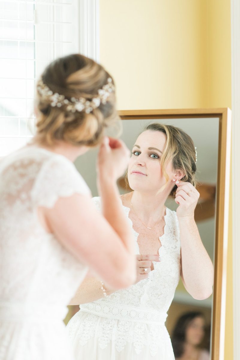 Saratoga Springs destination wedding photos in upstate New York by Mikkel Paige Photography, NY wedding photographer. The bride wore a boho lace gown an intimate wedding at a home with unique diamond earrings. #mikkelpaige #saratogaspringswedding #destinationwedding #bridestyle #bohobride #diamondearrings