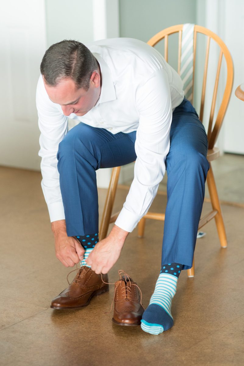 Pictures of the groom getting ready and putting on his brown leather shoes as he was getting ready for his wedding day. Their Saratoga Springs destination wedding photos in upstate New York are by Mikkel Paige Photography, NY wedding photographer. #mikkelpaige #saratogaspringswedding #destinationwedding #groomstyle #groomshoes