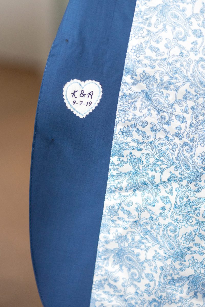 Detail picture of the custom date sewn into the groom's suit jacket. His Saratoga Springs destination wedding photos in upstate New York are by Mikkel Paige Photography, NY wedding photographer. #mikkelpaige #saratogaspringswedding #destinationwedding #groomstyle #weddingdetails