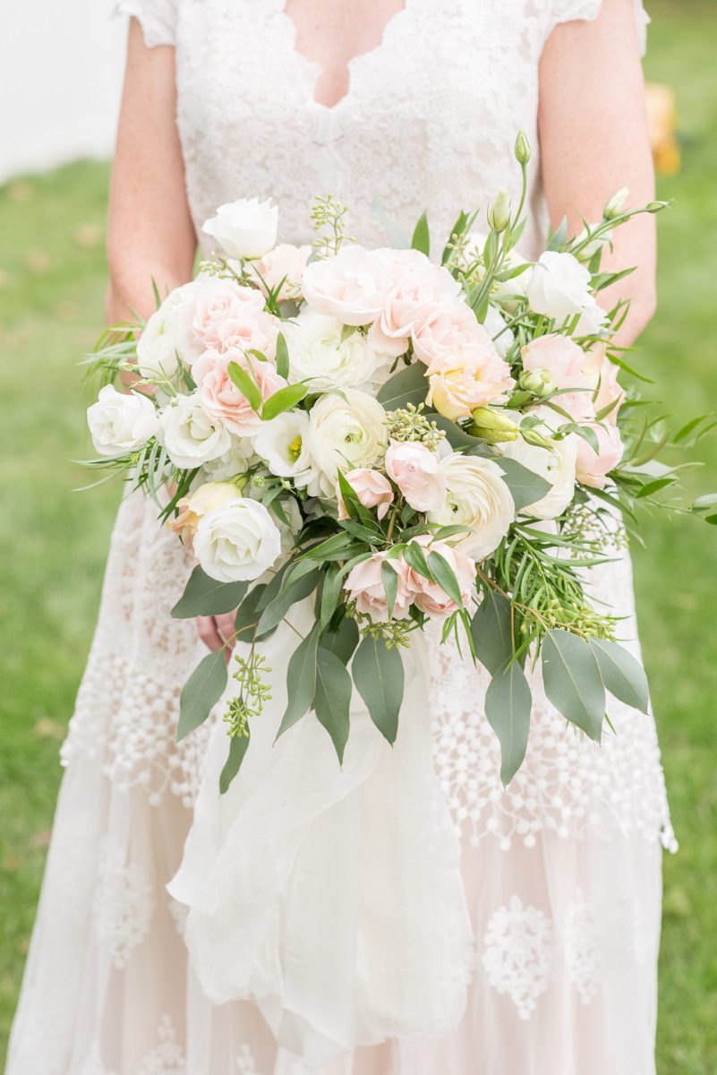 Saratoga Springs destination wedding photos in upstate New York by Mikkel Paige Photography, NY wedding photographer. The bride carried a bouquet with white hydrangea, eucalyptus and pink and peach roses. #mikkelpaige #saratogaspringswedding #destinationwedding #lakefrontwedding #lakewedding #bridestyle #eucalyptusbouquet #hydrangeabouquet #rosebouquet #pinkandpeach