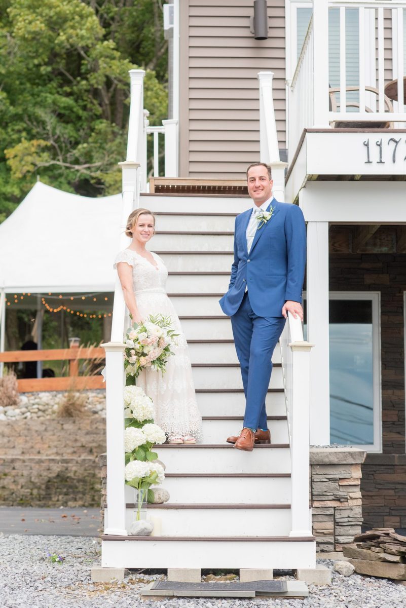 Saratoga Springs destination wedding photos in upstate New York by Mikkel Paige Photography, NY wedding photographer. The bride wore a boho lace gown and groom a blue suit with custom lining for an intimate wedding at a home. #mikkelpaige #saratogaspringswedding #destinationwedding #bridestyle #brideandgroom #groomstyle #customsuit #bohobride