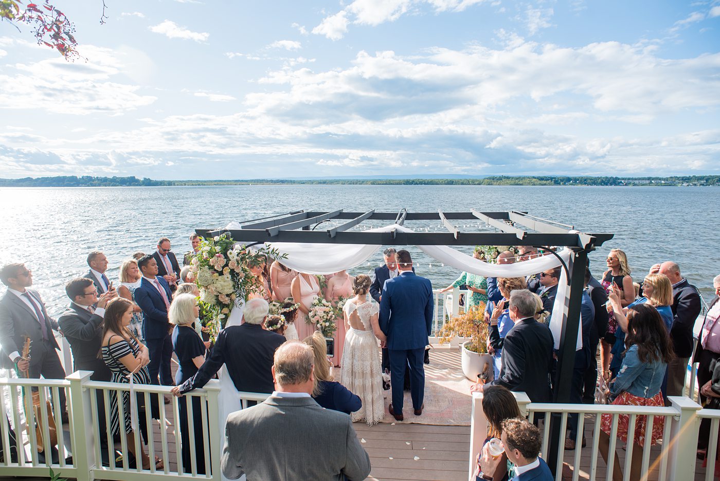 Saratoga Springs destination wedding photos in upstate New York by Mikkel Paige Photography, NY wedding photographer. The bride and groom were married in an intimate wedding at a home with a lakefront ceremony with Native American traditions. They had their dogs by their side as part of the ceremony! #mikkelpaige #saratogaspringswedding #destinationwedding #lakefrontwedding #waterfrontwedding #lakewedding