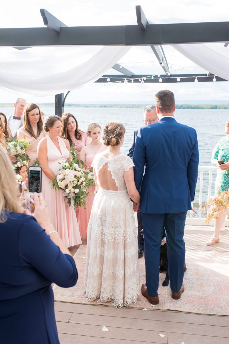 Saratoga Springs destination wedding photos in upstate New York by Mikkel Paige Photography, NY wedding photographer. The bride and groom were married in an intimate wedding at a home with a lakefront ceremony with Native American traditions. They had their dogs by their side as part of the ceremony! #mikkelpaige #saratogaspringswedding #destinationwedding #lakefrontwedding #waterfrontwedding #lakewedding