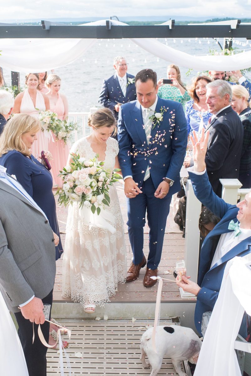 Saratoga Springs destination wedding photos in upstate New York by Mikkel Paige Photography, NY wedding photographer. The bride and groom were married in an intimate wedding at a home with a lakefront ceremony with Native American traditions. They had their dogs by their side as part of the ceremony! #mikkelpaige #saratogaspringswedding #destinationwedding #lakefrontwedding #waterfrontwedding #lakewedding