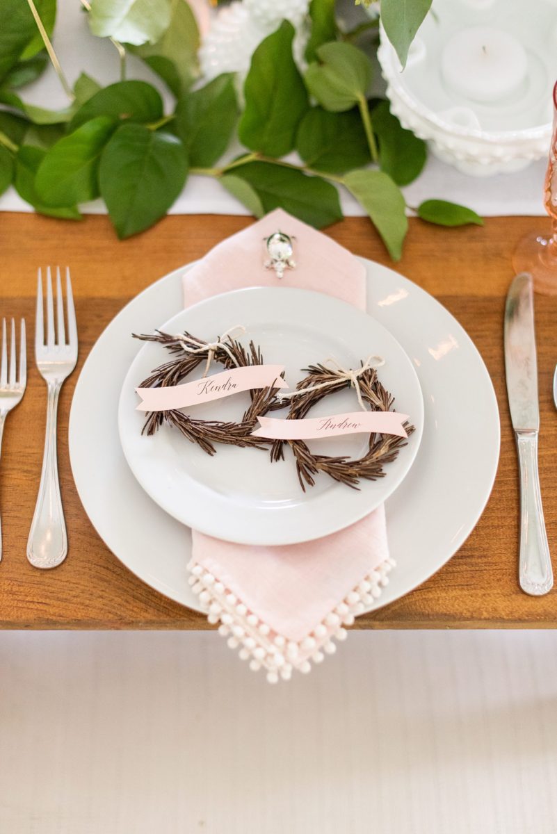 Saratoga Springs destination wedding photos in upstate New York by Mikkel Paige Photography, NY wedding photographer. The bride and groom tented a lawn for their reception. They had wood Chiavari chairs, milk glass and vintage salt and pepper shakers on each table. The table numbers were destinations the couple had been. #mikkelpaige #saratogaspringswedding #destinationwedding #lakefrontwedding #waterfrontwedding #lakewedding #tablenumbers #weddingreception #intimatewedding