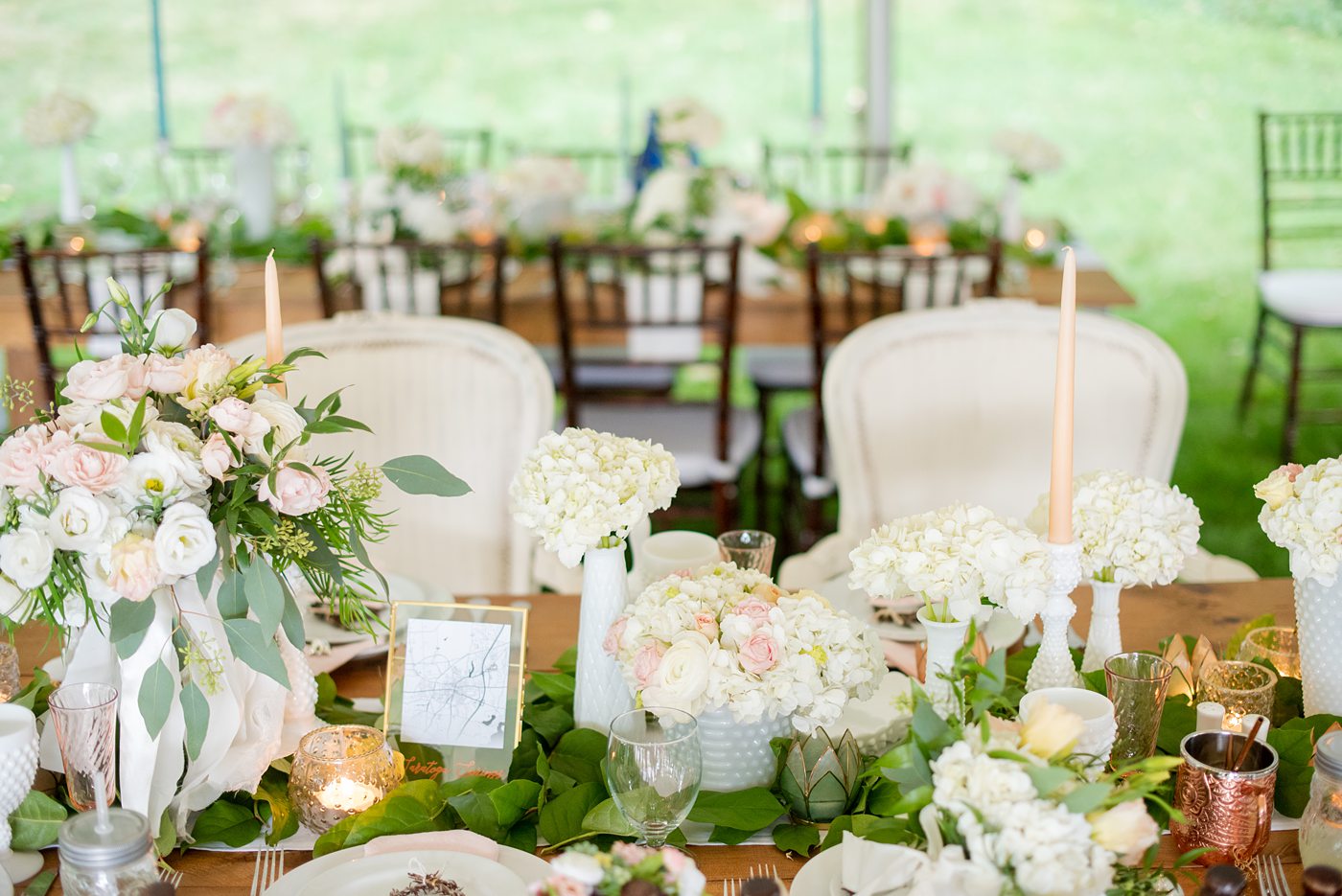 Saratoga Springs destination wedding photos in upstate New York by Mikkel Paige Photography, NY wedding photographer. The bride and groom tented a lawn for their reception. They had wood Chiavari chairs, milk glass and vintage salt and pepper shakers on each table. The table numbers were destinations the couple had been. #mikkelpaige #saratogaspringswedding #destinationwedding #lakefrontwedding #waterfrontwedding #lakewedding #tablenumbers #weddingreception #intimatewedding