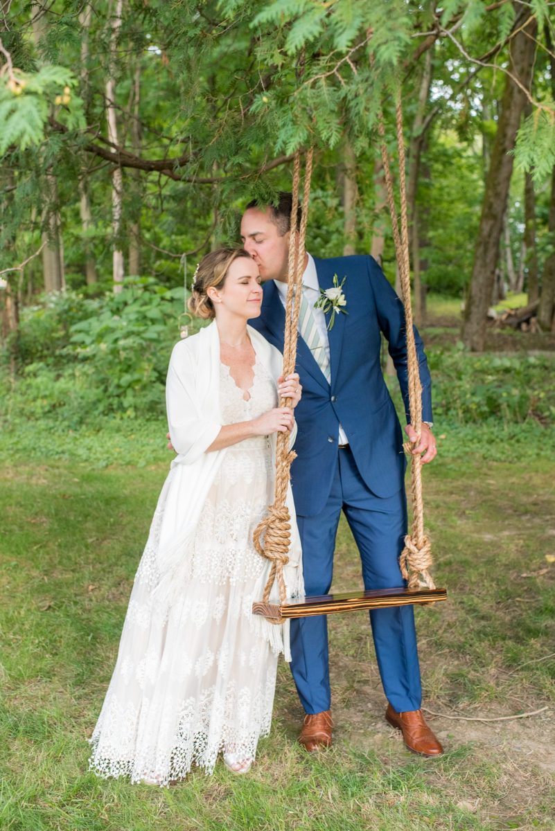 Saratoga Springs destination wedding photos in upstate New York by Mikkel Paige Photography, NY wedding photographer. The bride wore a boho lace gown and groom a blue suit with custom lining for an intimate wedding at a home. #mikkelpaige #saratogaspringswedding #destinationwedding #bridestyle #brideandgroom #groomstyle #customsuit #bohobride