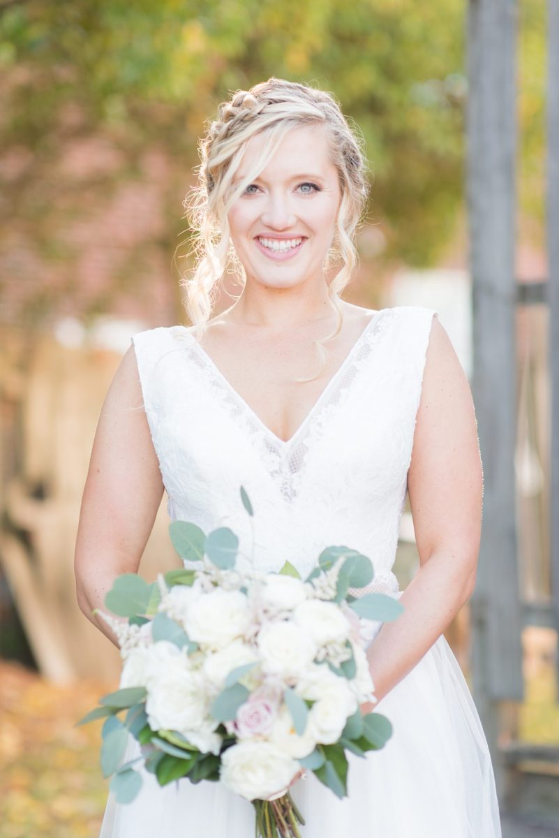 Chatham Station wedding photos my Mikkel Paige Photography from this urban chic beautiful venue in Cary, North Carolina. The bride wore beaded white v-neck gown with a tulle skirt for her wedding fall celebration. #mikkelpaige #RaleighWeddingphotographer #chathamstation #CaryNC #weddingvenues #bridestyle #bridaljacket 