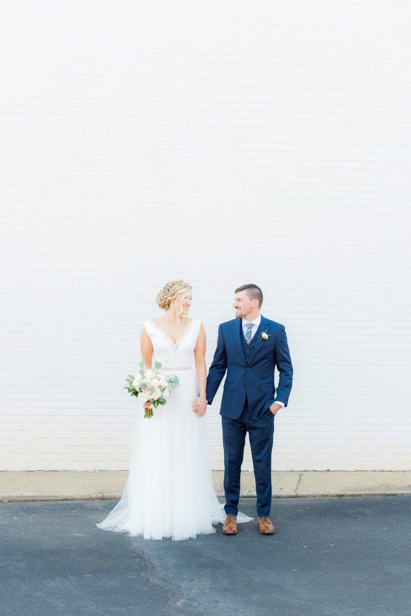 Chatham Station wedding photos my Mikkel Paige Photography from this urban chic beautiful venue in Cary, North Carolina. Picture of the bride in a white tulle gown and groom in a blue suit. #mikkelpaige #RaleighWeddingphotographer #chathamstation #CaryNC #weddingvenues #brideandgroom