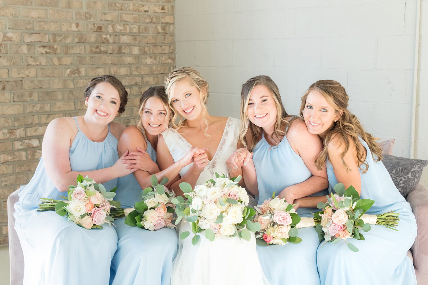 Chatham Station wedding photos my Mikkel Paige Photography from this urban chic beautiful venue in Cary, North Carolina. Picture of the bride and bridesmaids in light blue chiffon gowns. #mikkelpaige #RaleighWeddingphotographer #chathamstation #CaryNC #weddingvenues #bridestyle #bridesmaids