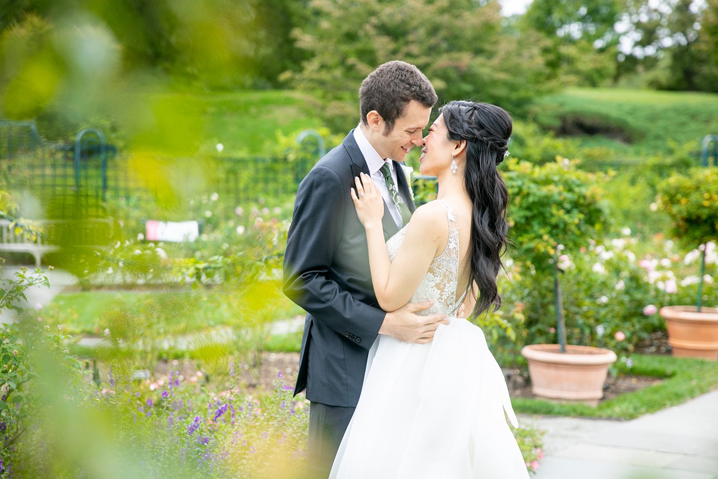 New York Botanical Garden wedding photos by Mikkel Paige Photography. The groom wore a green tie with floral detail and gray suit and bride a beaded ballgown with bow on the back. After the couple's engagement photoshoot in Manhattan I was so excited for their fall wedding near the Conservatory at the Terrace Room, at this NYC venue. #mikkelpaige #nybg #asianbride #bridestyle #brideandgroom #newyorkbotanicalgardenwedding #groomstyle #NYBotanicalGarden #Bronxwedding #newyorkcityweddingvenue