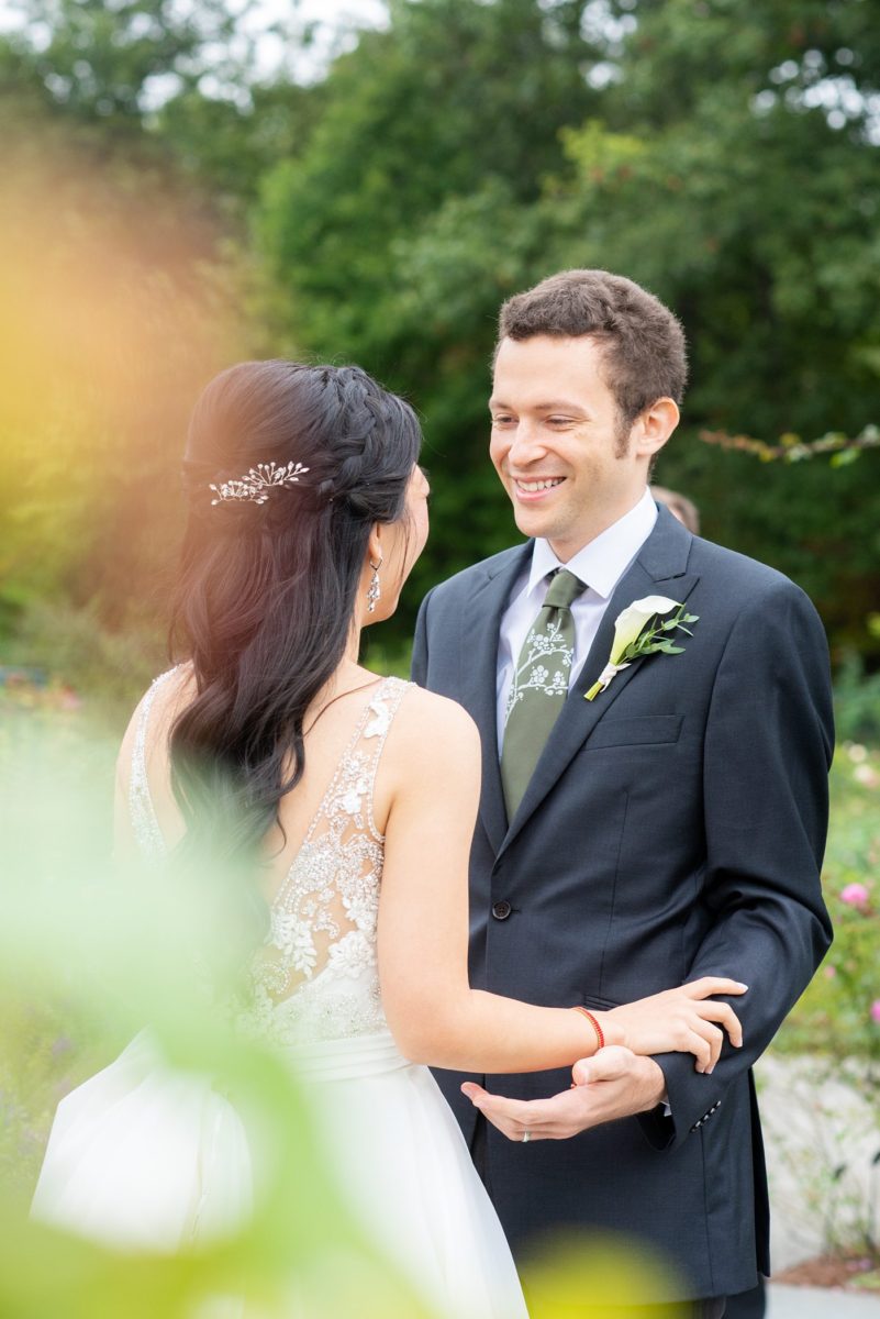 New York Botanical Garden wedding photos by Mikkel Paige Photography. The groom wore a green tie with floral detail and gray suit and bride a beaded ballgown with bow on the back. After the couple's engagement photoshoot in Manhattan I was so excited for their fall wedding near the Conservatory at the Terrace Room, at this NYC venue. #mikkelpaige #nybg #asianbride #bridestyle #brideandgroom #newyorkbotanicalgardenwedding #groomstyle #NYBotanicalGarden #Bronxwedding #newyorkcityweddingvenue