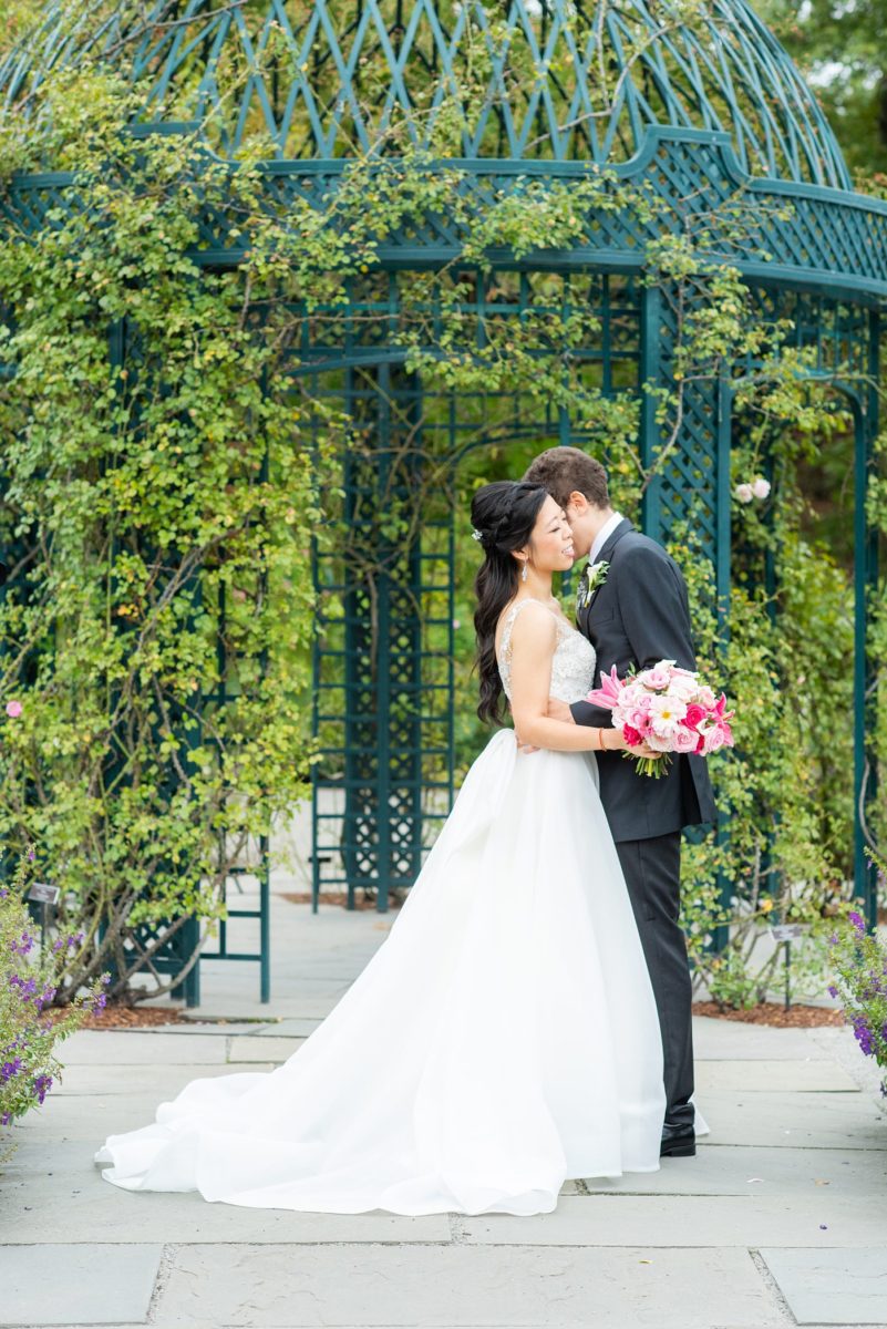 New York Botanical Garden wedding photos by Mikkel Paige Photography. The groom wore a green tie with floral detail and gray suit and bride a beaded ballgown with bow on the back. After the couple's engagement photoshoot in Manhattan I was so excited for their fall wedding near the Conservatory at the Terrace Room, at this NYC venue. #mikkelpaige #nybg #asianbride #bridestyle #brideandgroom #newyorkbotanicalgardenwedding #groomstyle #NYBotanicalGarden #Bronxwedding #newyorkcityweddingvenue