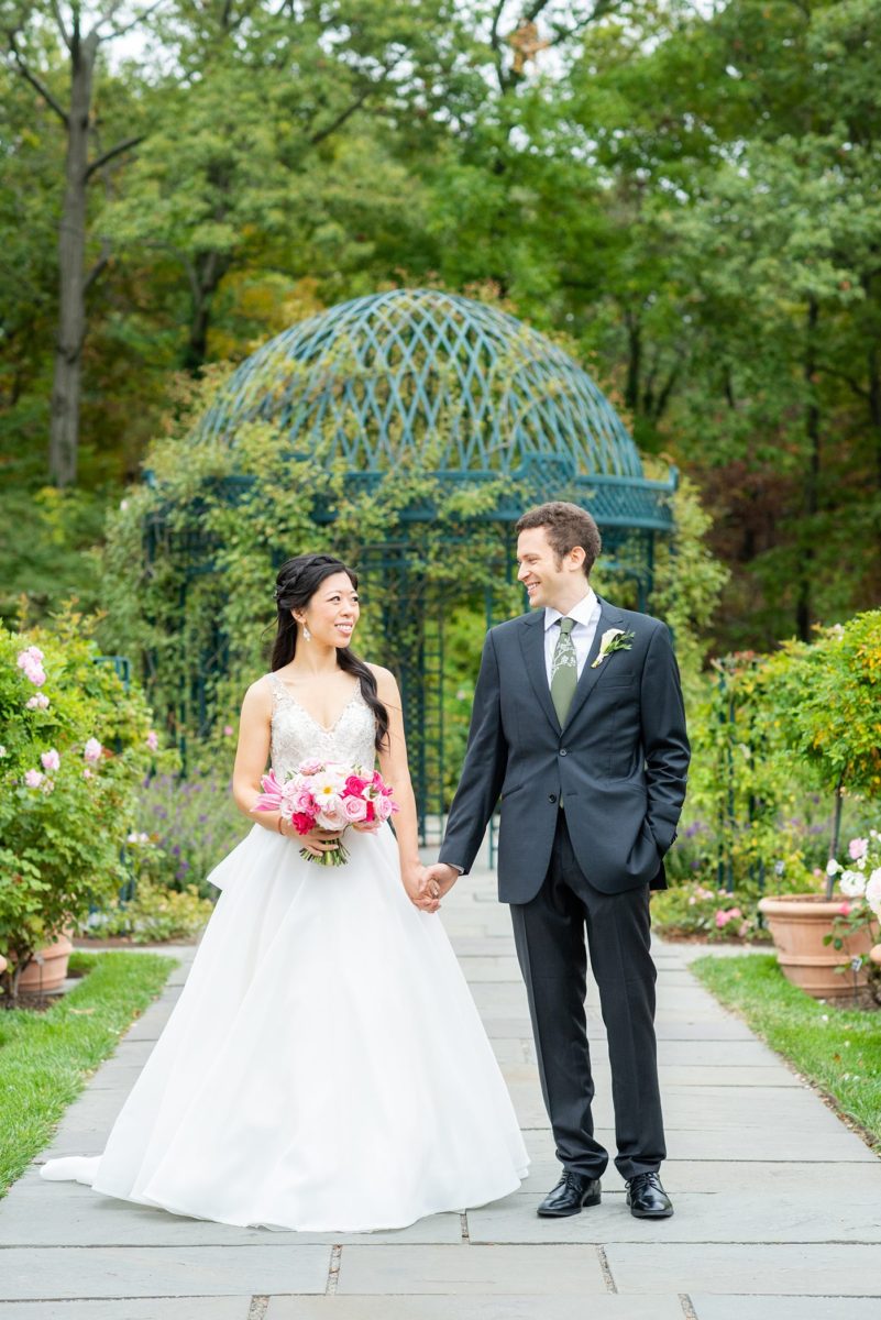 New York Botanical Garden wedding photos by Mikkel Paige Photography. The groom wore a green tie with floral detail and gray suit and bride a beaded ballgown with bow on the back. After the couple's engagement photoshoot in Manhattan I was so excited for their fall wedding near the Conservatory at the Terrace Room, at this NYC venue. #mikkelpaige #nybg #asianbride #bridestyle #brideandgroom #newyorkbotanicalgardenwedding #groomstyle #NYBotanicalGarden #Bronxwedding #newyorkcityweddingvenue