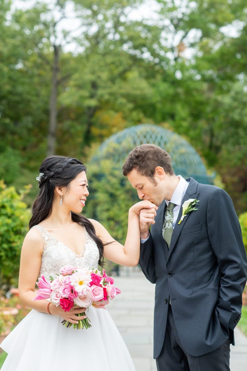 New York Botanical Garden wedding photos by Mikkel Paige Photography. The groom wore a green tie with floral detail and gray suit and bride a beaded ballgown with bow on the back. After the couple's engagement photoshoot in Manhattan I was so excited for their fall wedding near the Conservatory at the Terrace Room, at this NYC venue. #mikkelpaige #nybg #asianbride #bridestyle #brideandgroom #newyorkbotanicalgardenwedding #groomstyle #NYBotanicalGarden #Bronxwedding #newyorkcityweddingvenue