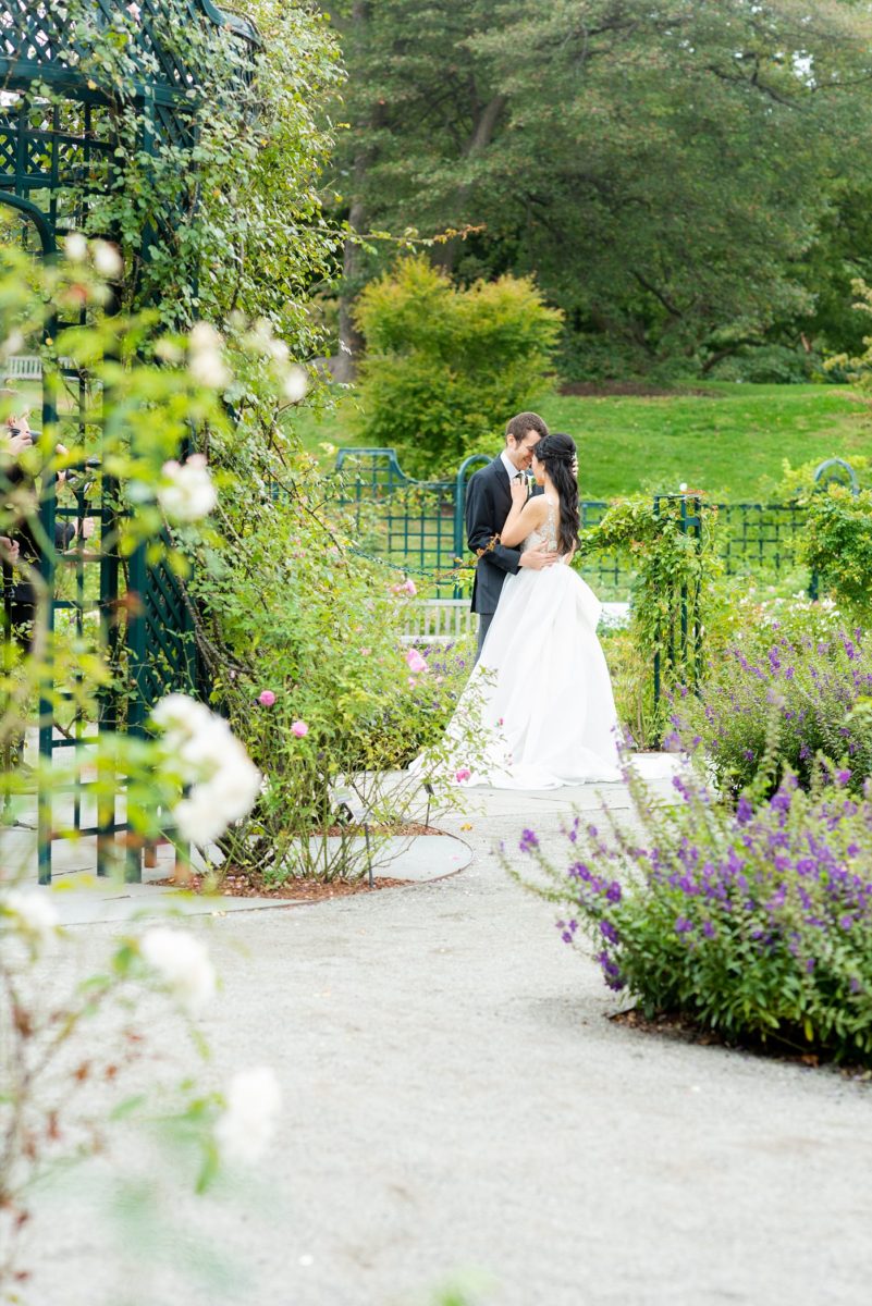 New York Botanical Garden wedding photos by Mikkel Paige Photography. The groom wore a green tie with floral detail and gray suit and bride a beaded ballgown with bow on the back. After the couple's engagement photoshoot in Manhattan I was so excited for their fall wedding near the Conservatory at the Terrace Room, at this NYC venue. #mikkelpaige #nybg #asianbride #bridestyle #brideandgroom #newyorkbotanicalgardenwedding #groomstyle #NYBotanicalGarden #Bronxwedding #newyorkcityweddingvenue