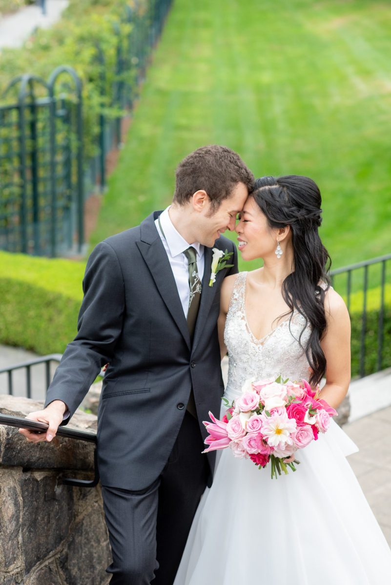 New York Botanical Garden wedding photos by Mikkel Paige Photography. The groom wore a green tie with floral detail and gray suit and bride a beaded ballgown with bow on the back. After the couple's engagement photoshoot in Manhattan I was so excited for their fall wedding near the Conservatory at the Terrace Room, at this NYC venue. #mikkelpaige #nybg #asianbride #bridestyle #brideandgroom #newyorkbotanicalgardenwedding #groomstyle #NYBotanicalGarden #Bronxwedding #newyorkcityweddingvenue