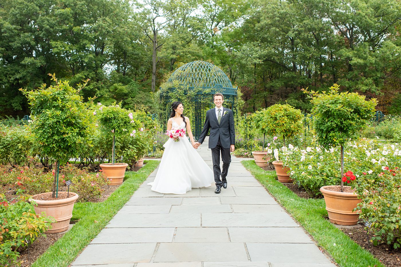 New York Botanical Garden wedding photos by Mikkel Paige Photography. The groom wore a green tie with floral detail and gray suit and bride a beaded ballgown with bow on the back. After the couple's engagement photoshoot in Manhattan I was so excited for their fall wedding near the Conservatory at the Terrace Room, at this NYC venue. #mikkelpaige #nybg #asianbride #bridestyle #brideandgroom #newyorkbotanicalgardenwedding #groomstyle #NYBotanicalGarden #Bronxwedding #newyorkcityweddingvenue