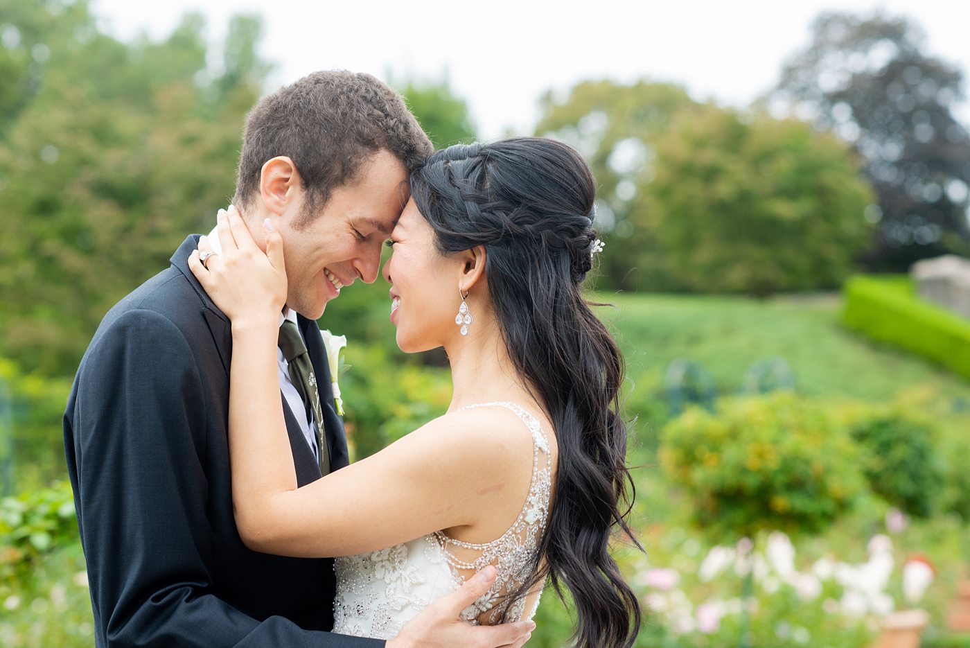 New York Botanical Garden wedding photos by Mikkel Paige Photography. The groom wore a green tie with floral detail and gray suit and bride a beaded ballgown with bow on the back. After the couple's engagement photoshoot in Manhattan I was so excited for their fall wedding near the Conservatory at the Terrace Room, at this NYC venue. #mikkelpaige #nybg #asianbride #bridestyle #brideandgroom #newyorkbotanicalgardenwedding #groomstyle #NYBotanicalGarden #Bronxwedding #newyorkcityweddingvenue