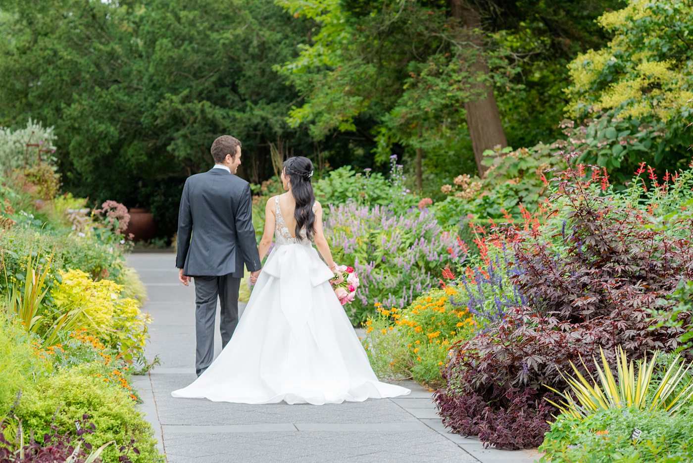 New York Botanical Garden wedding photos by Mikkel Paige Photography. The groom wore a green tie with floral detail and gray suit and bride a beaded ballgown with bow on the back. After the couple's engagement photoshoot in Manhattan I was so excited for their fall wedding near the Conservatory at the Terrace Room, at this NYC venue. #mikkelpaige #nybg #asianbride #bridestyle #brideandgroom #newyorkbotanicalgardenwedding #groomstyle #NYBotanicalGarden #Bronxwedding #newyorkcityweddingvenue