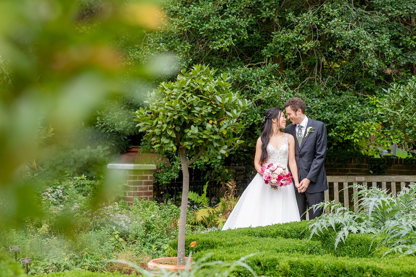 New York Botanical Garden wedding photos by Mikkel Paige Photography. The groom wore a green tie with floral detail and gray suit and bride a beaded ballgown with bow on the back. After the couple's engagement photoshoot in Manhattan I was so excited for their fall wedding near the Conservatory at the Terrace Room, at this NYC venue. #mikkelpaige #nybg #asianbride #bridestyle #brideandgroom #newyorkbotanicalgardenwedding #groomstyle #NYBotanicalGarden #Bronxwedding #newyorkcityweddingvenue