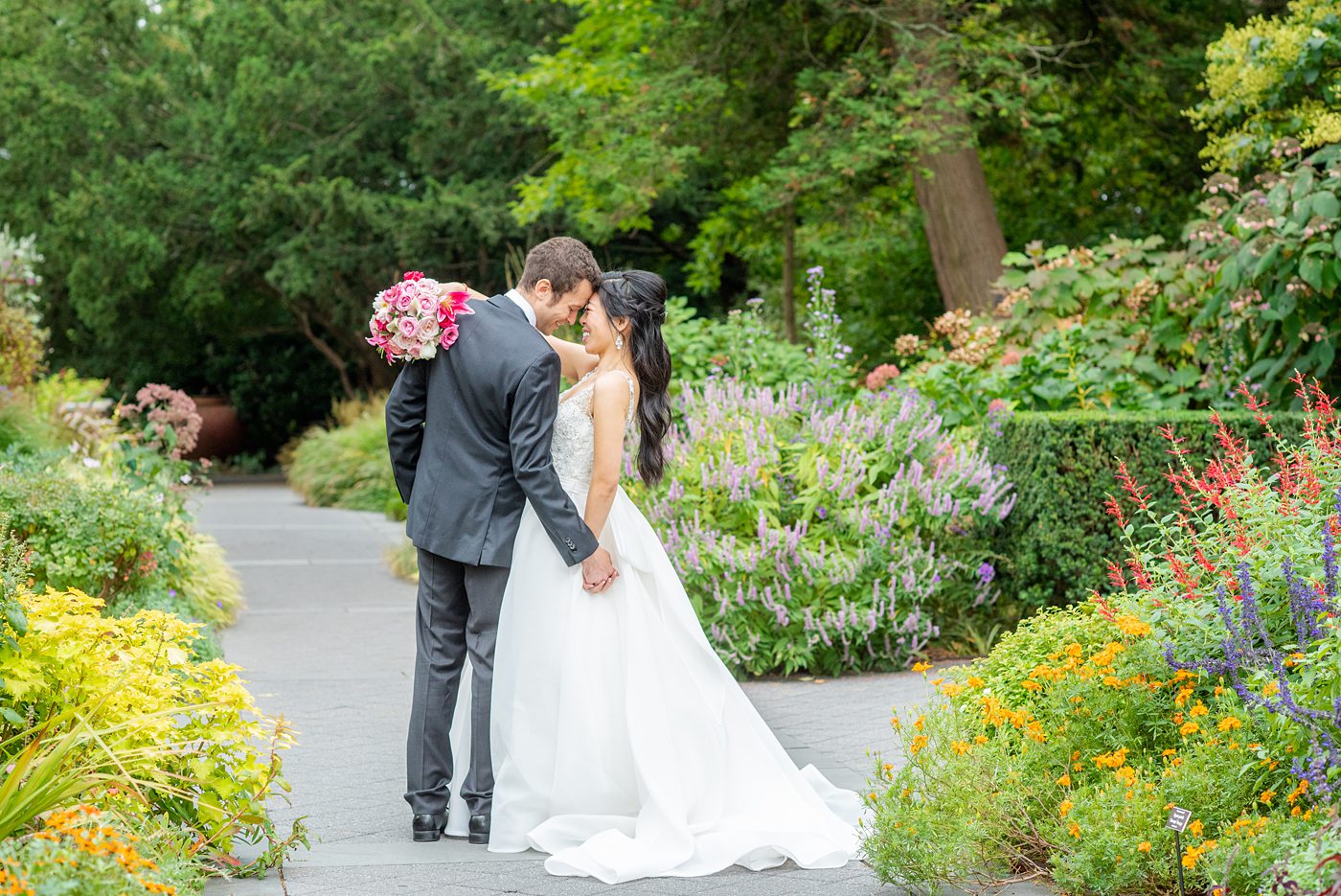 New York Botanical Garden wedding photos by Mikkel Paige Photography. The groom wore a green tie with floral detail and gray suit and bride a beaded ballgown with bow on the back. After the couple's engagement photoshoot in Manhattan I was so excited for their fall wedding near the Conservatory at the Terrace Room, at this NYC venue. #mikkelpaige #nybg #asianbride #bridestyle #brideandgroom #newyorkbotanicalgardenwedding #groomstyle #NYBotanicalGarden #Bronxwedding #newyorkcityweddingvenue