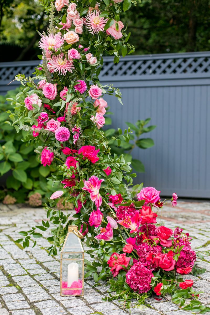 Outdoor ceremony at a New York Botanical Garden wedding photos by Mikkel Paige Photography. After the couple's engagement photoshoot in Manhattan I was so excited for their fall wedding near the Conservatory at the Terrace Room, at this NYC venue. Their backdrop was an ombre flower circle with pink and red blooms. #mikkelpaige #nybg #newyorkbotanicalgardenwedding #asianbride #NYBotanicalGarden #Bronxwedding #newyorkcityweddingvenues #weddingceremony #ombreflowers