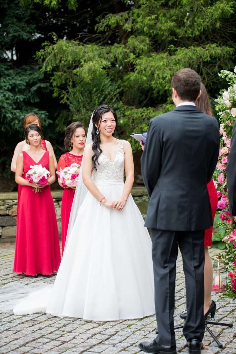 Outdoor ceremony at a New York Botanical Garden wedding photos by Mikkel Paige Photography. After the couple's engagement photoshoot in Manhattan I was so excited for their fall wedding near the Conservatory at the Terrace Room, at this NYC venue. Their backdrop was an ombre flower circle with pink and red blooms. #mikkelpaige #nybg #newyorkbotanicalgardenwedding #asianbride #NYBotanicalGarden #Bronxwedding #newyorkcityweddingvenues #weddingceremony #ombreflowers