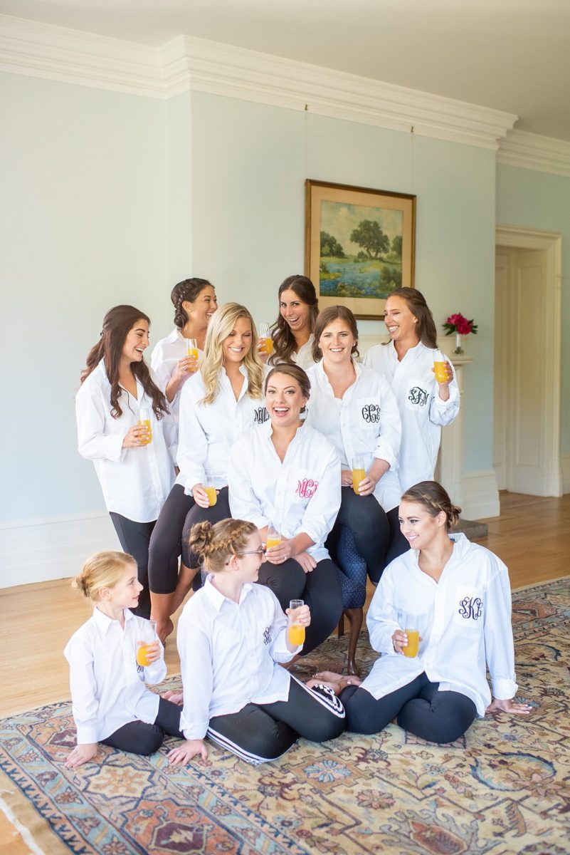 Photos by Mikkel Paige Photography at Waveny House wedding venue in New Canaan, Connecticut. This beautiful venue has an outdoor garden for the ceremony and indoor historic home for the reception. The bride got ready in the main house with her mother and bridesmaids, who wore custom embroidered button down shirts. #mikkelpaige #wavenyhouse #wavenyhousewedding #connecticutweddingvenue #connecticutweddingphotographer #gettingready #bridesmaidsshirts #monogrammedshirts #embroideredshirts