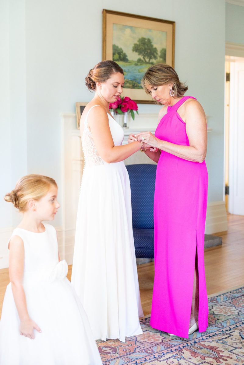 Photos by Mikkel Paige Photography at Waveny House wedding venue in New Canaan, Connecticut. This beautiful venue has an outdoor garden for the ceremony and indoor historic home for the reception. The bride got ready in the main house with her mother and wore a special "something blue" family heirloom bracelet from her grandmother. #mikkelpaige #wavenyhouse #wavenyhousewedding #connecticutweddingvenue #connecticutweddingphotographer #gettingready #somethingblue #motherofthebride #familyheirloom
