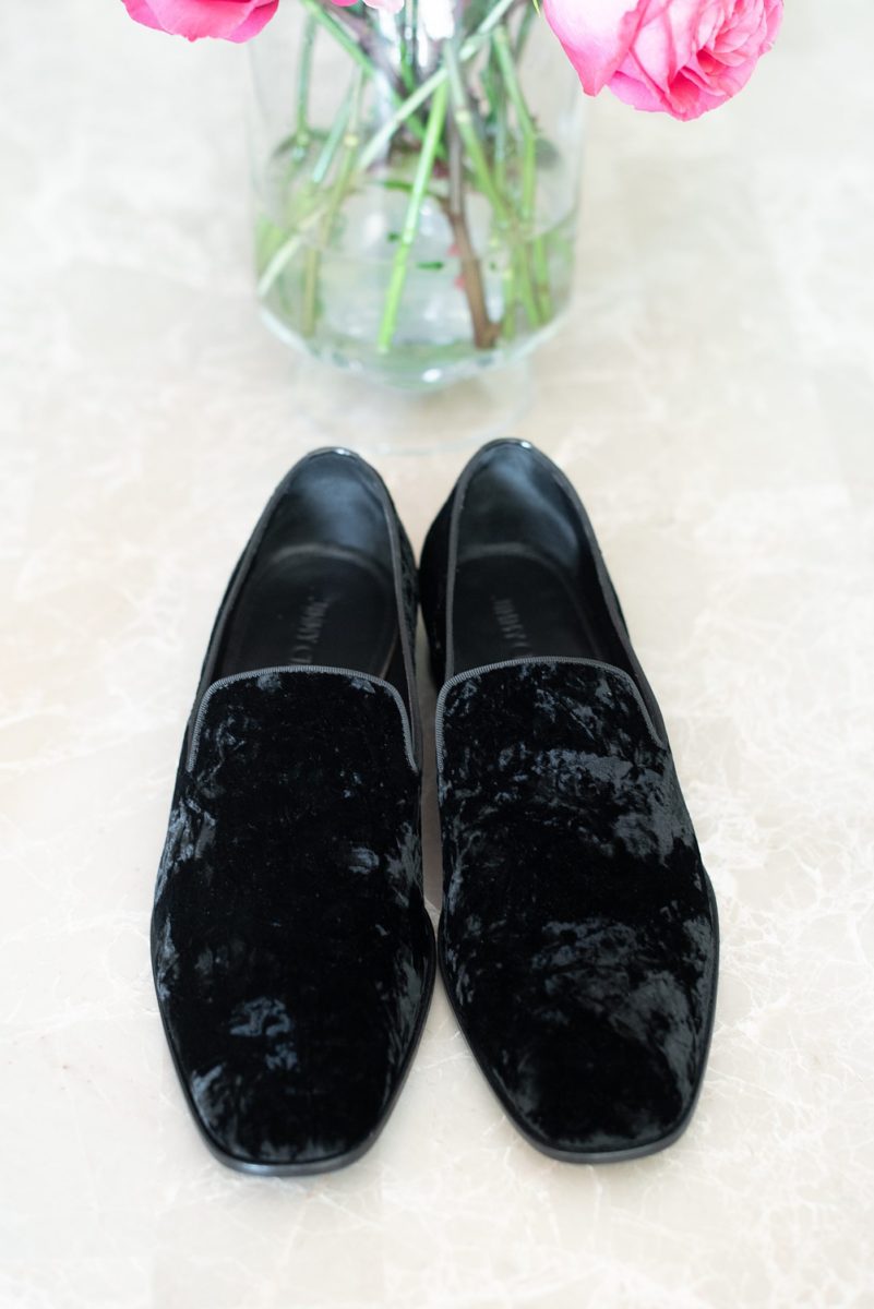 Detail photo of the groom's black velvet shoes by Mikkel Paige Photography. The wedding was at the Waveny House in New Canaan, Connecticut. This beautiful venue has an outdoor garden for the ceremony and indoor historic home for the wedding reception. #mikkelpaige #wavenyhouse #wavenyhousewedding #connecticutweddingvenue #connecticutweddingphotographer #gettingready #groomstyle #velvetshoes #blackvelvet